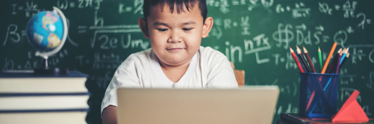 kid  use computer laptop  in the classroom.
